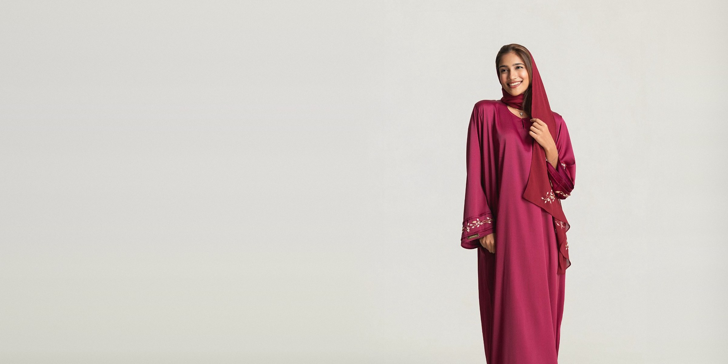 The Saffron abaya set in ruby, with hand-embroidered sleeves and matching hijab